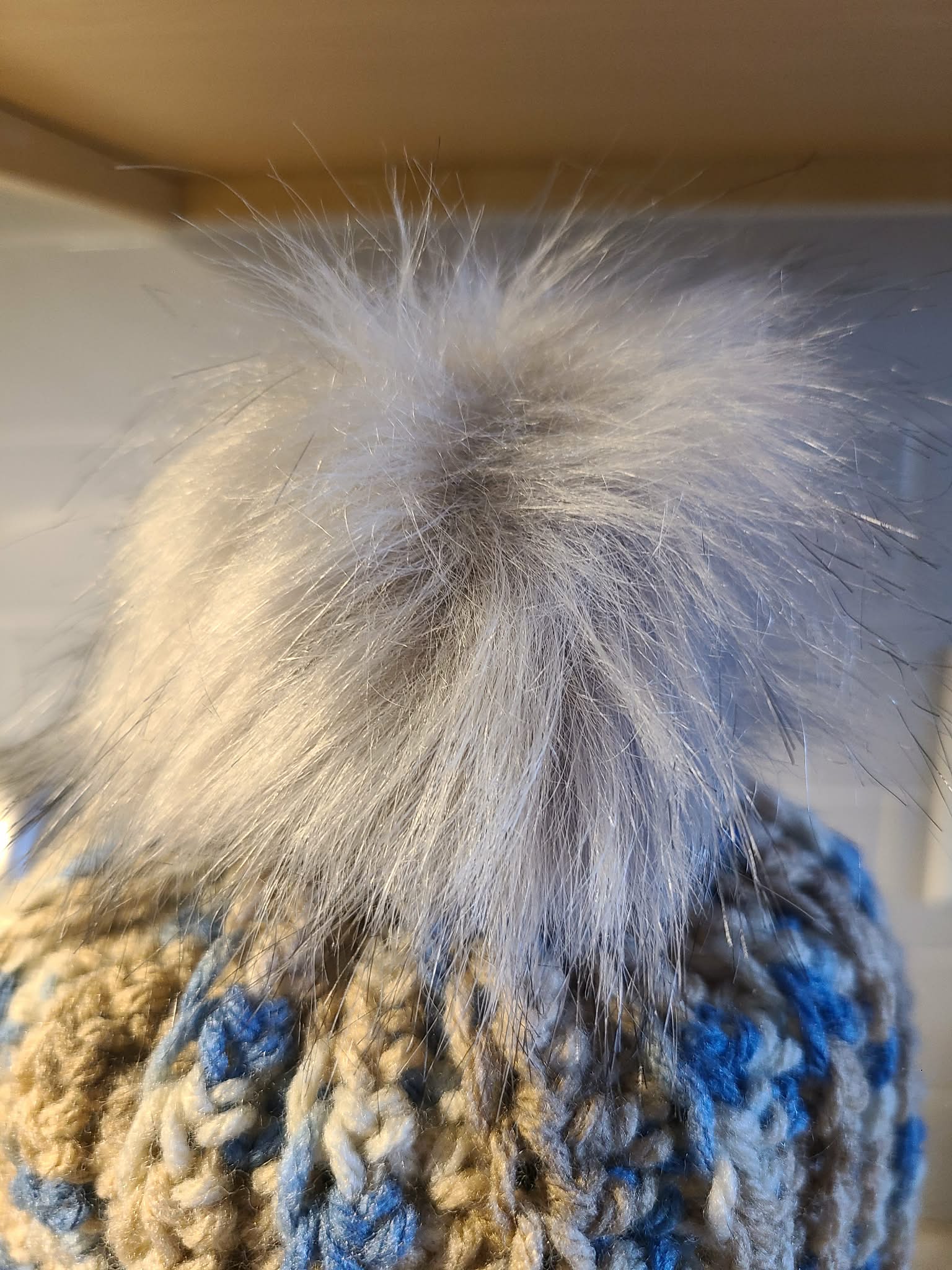 Close-up of a silver faux fir fluffy pom-pom