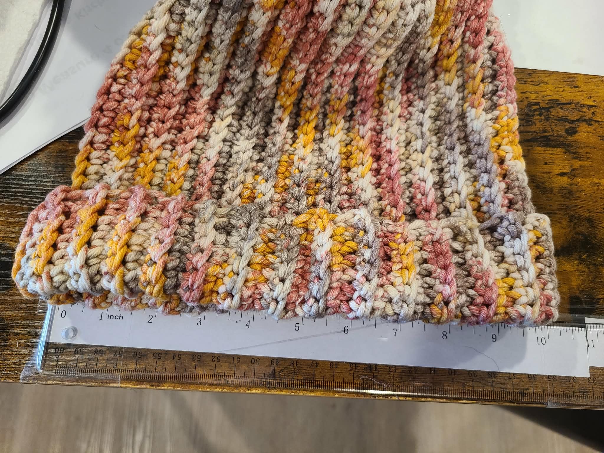 Textured fabric with a ruler for scale on a wooden surface